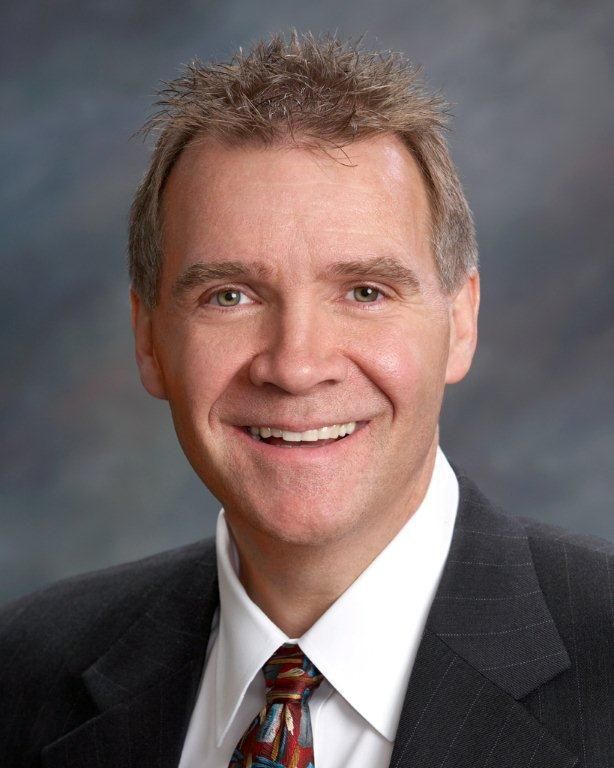 Professional man in a suit representing the Home Builders Association of Billings.