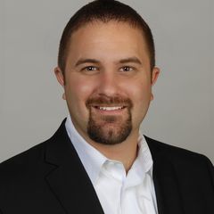 Construction professional smiling in a suit, representing the Home Builders Association of Billings.